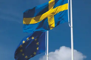 A Swedish flag in front of an EU flag